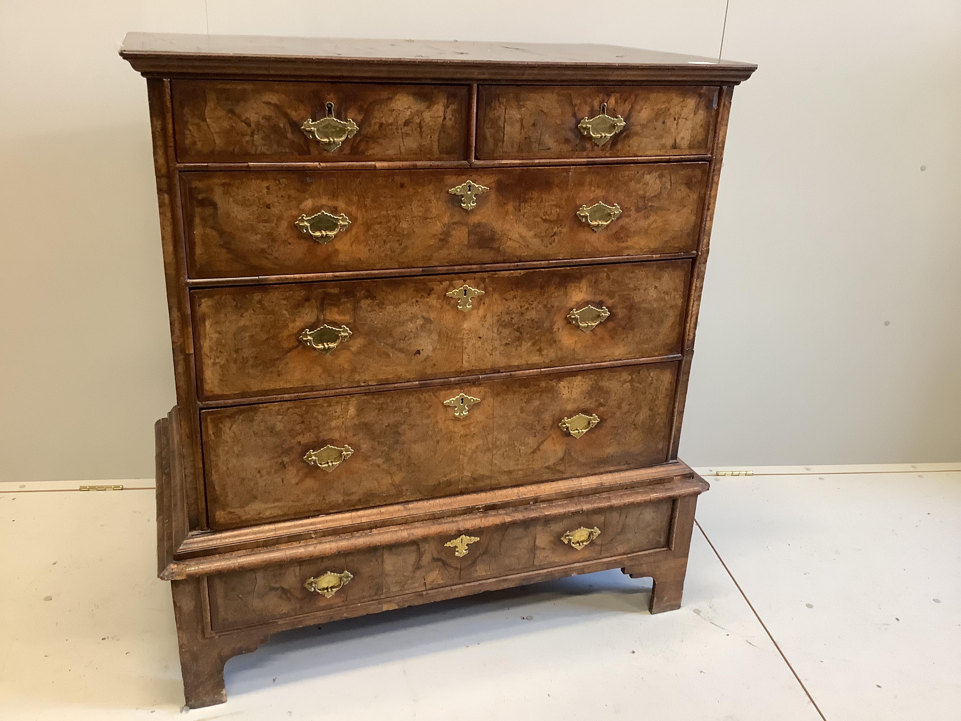 An 18th century feather banded walnut chest on stand, width 105cm, depth 58cm, height 117cm
